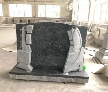 Blue-green granite upright with carved scrollwork