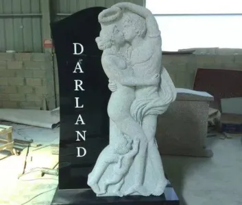 Black upright with carved embracing figures