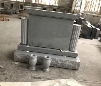 Grey upright memorial with columns and matching vases