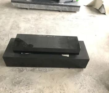 Polished black bevel marker on a granite base